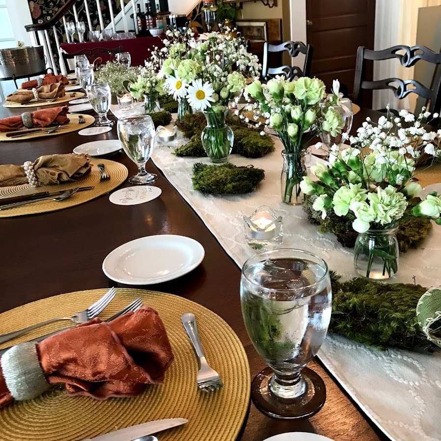 A beautifully arranged dining table adorned with floral centerpieces and elegant place settings.